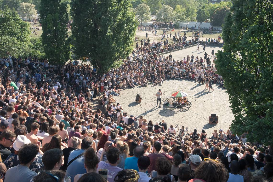 A large crowd gathers to watch the open-air karaoke session in Mauerpark, Berlin